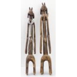 Two stylised, carved African softwood elongated figure carvings; one with beadwork hanging (being