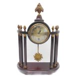An early 20th century mahogany and brass-mounted mantle clock in classical style; the central finial