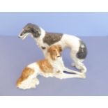 A large continental porcelain model of two Saluki-type dogs; paper label, printed marks and