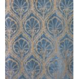 A heavy pair of curtains in a sumptuous blue and gold velvet damask brocade fabric with deep plaited