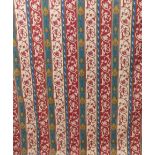 A pair of tapestry weave effect curtains in a red and green medieval style pattern, goblet headings,