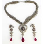 An 18-carat white gold, ruby and diamond necklace, earrings and multi-strand neck chain