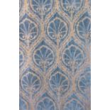 A heavy pair of curtains in a sumptuous blue and gold velvet damask brocade fabric with deep plaited