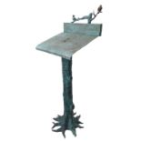A highly unusual patinated bronze lectern stand modelled as a tree trunk with spreading roots;