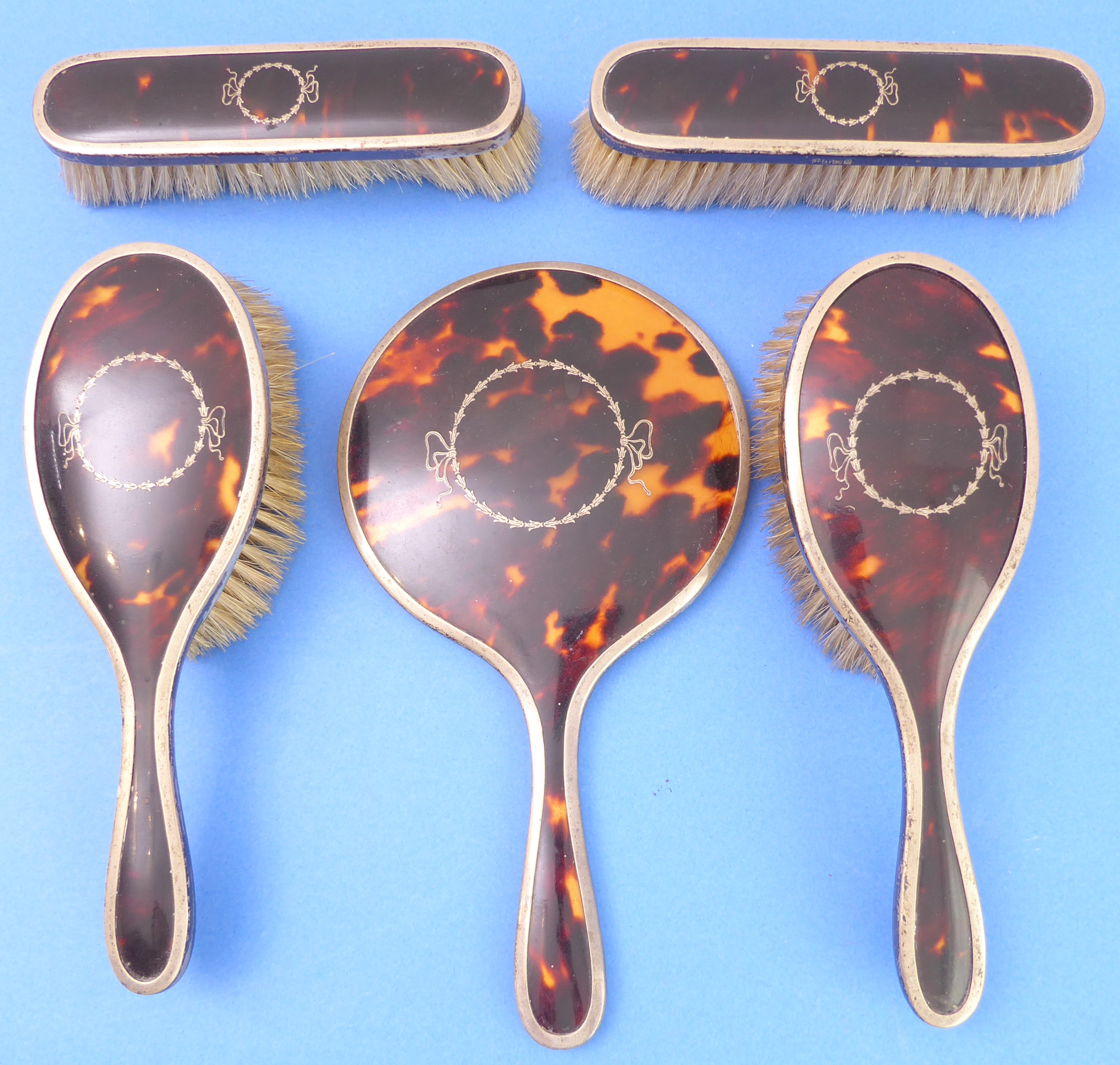 A circa 1925 tortoiseshell and hallmarked silver mounted dressing table set decorated with pique