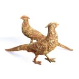 A pair of ornamental cast-iron garden ornaments modelled as two hen pheasants (44cm long) (2)