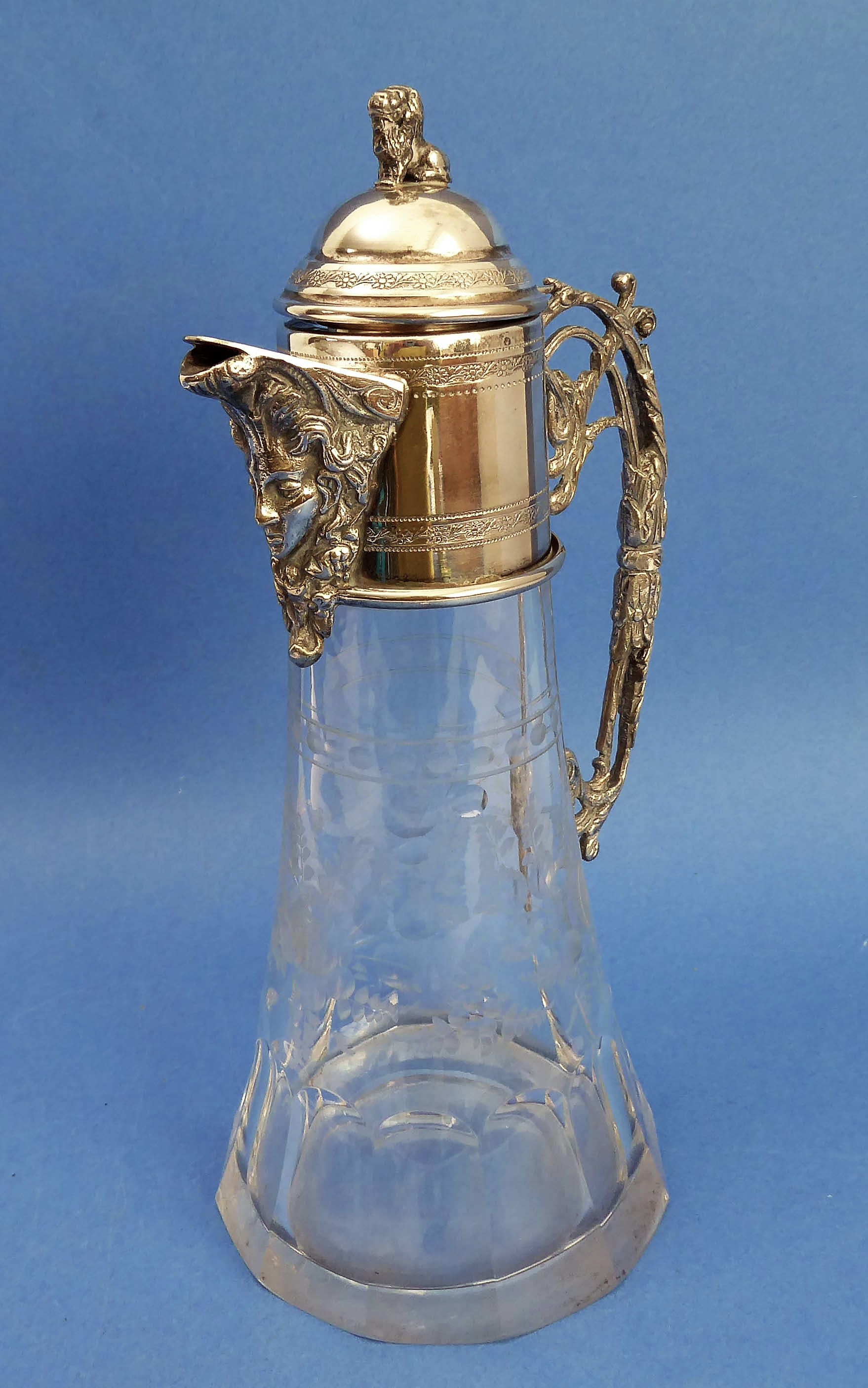 An ornate late 19th century claret jug with silver-plated mounts