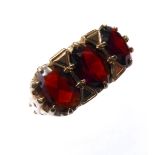 A 9-carat gold dress ring set with three red garnets, ring size N (boxed)