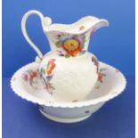 An early 19th century ceramic jug and bowl set; hand-decorated with various floral sprays (some