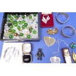 A small selection of costume jewellery to include a hallmarked silver bangle, sterling charms, a