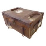 A large early 20th century leather-mounted travelling trunk complete with the remnants of various