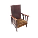 An early 20th century Arts and Crafts style adjustable armchair with square chamfered front legs (