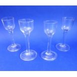 Four similar 18th century style ale / cordial glasses; each with spreading circular foot (14.75cm)