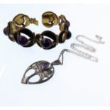 A Guild of Handicrafts silver and amethyst pendant with chain, the obovoid pendant depicting a