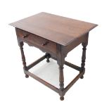 An 18th century oak side table: the overhanging moulded top above single full width drawer with