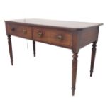 An early 19th century deep mahogany sideboard: the reeded edge slightly overhanging top above two
