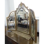 A gilt-framed triple folding dressing-table mirror: in Venetian style with hand-bevelling and