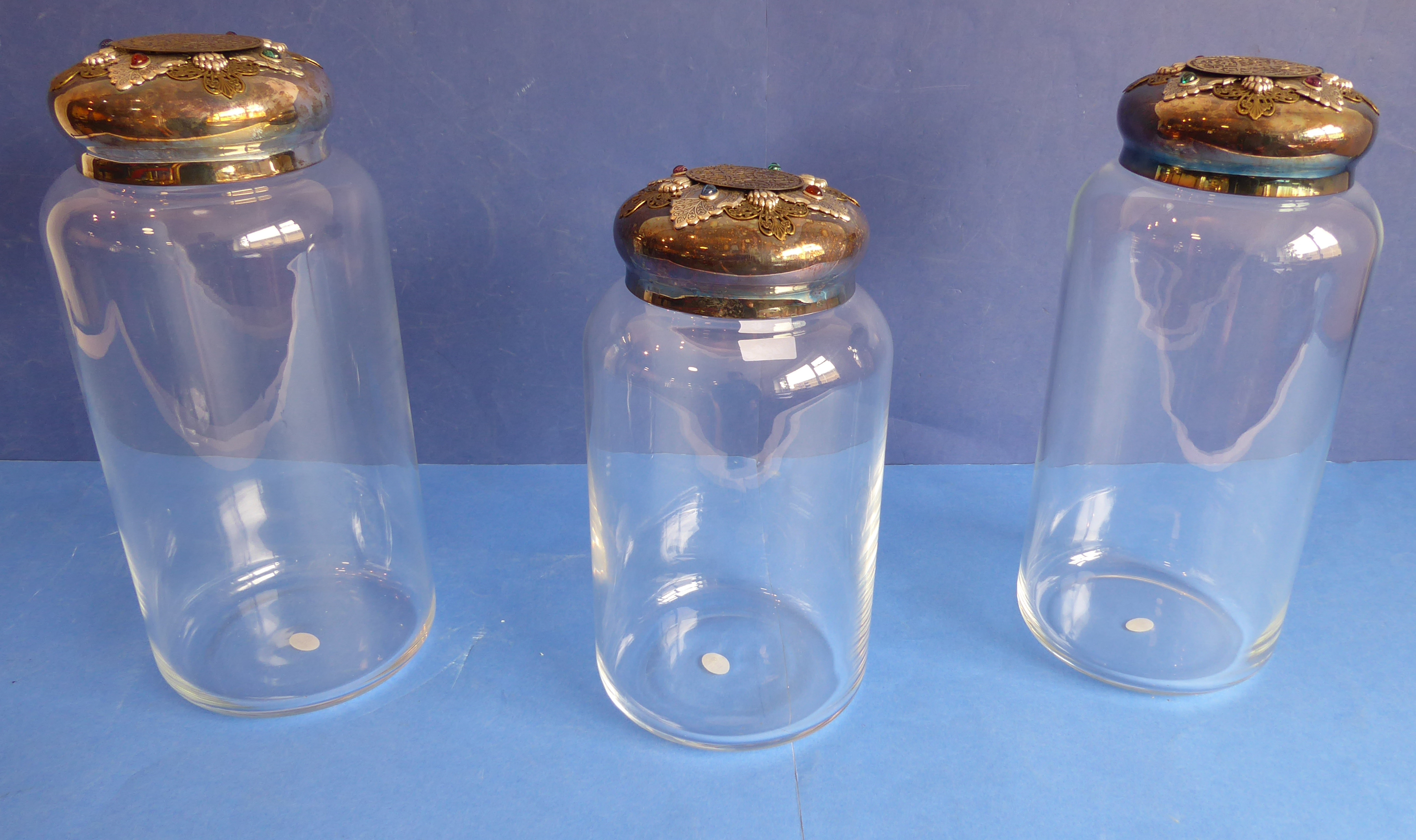 ANN CICHON (Dallas): a pair of large cylindrical clear-glass jars with silver-plated lids with