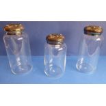 ANN CICHON (Dallas): a pair of large cylindrical clear-glass jars with silver-plated lids with