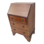 An Edwardian mahogany and chequer strung writing bureau of slim proportions: the one piece angular