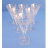 A set of six early 19th century cordial glasses of faceted, conical form and engraved with