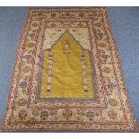A 19th century Turkish silk prayer rug (possibly Kersehir); the golden-yellow prayer niche with