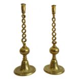 A pair of large and heavy cast-brass table candlesticks of open barleytwist form and with bell-