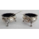 A pair of hallmarked silver salts with cobalt-blue glass liners: the salts with gilded interiors and