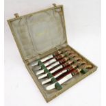 A cased set of six Royal Crown Derby tea knives having porcelain pistol grip style handles hand