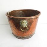 A 19th century circular riveted copper copper with two brass lion-mask ring-handles (47cm diameter