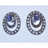 A pair of oval openwork white gold tanzanite and diamond cluster earrings