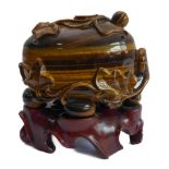 A very finely carved Chinese tiger's eye hardstone oval box-and-cover, the exterior decorated with