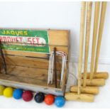 A pine-cased Jaques croquet set comprising mallets, markers, hoops, various balls and