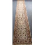 A cream-ground Pakistan runner, with floral foliage to the central rectangle, similarly repeating