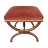 An early 19th century crossframe mahogany stool: fluted support and turned stretcher (