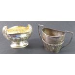 A hallmarked silver sugar bowl: the two handles modelled as scallop shells, maker's mark HA, assayed