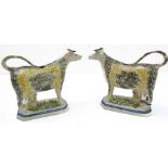 A pair of early 19th century Prattware-style pottery cow creamers (minus covers): each with curled