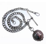 A silver tapering curb link chain necklace with T-bar, swivel and circular disc. (length 34.5cm,