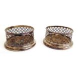 A pair of Sheffield plated wine coasters of pierced high-sided form with turned wooden bases and