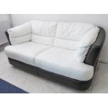 A fine modern two-seater leather sofa: white-leather seats; dark-grey base, sides and back (