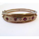 A Victorian 9-carat gold, ruby and diamond bangle