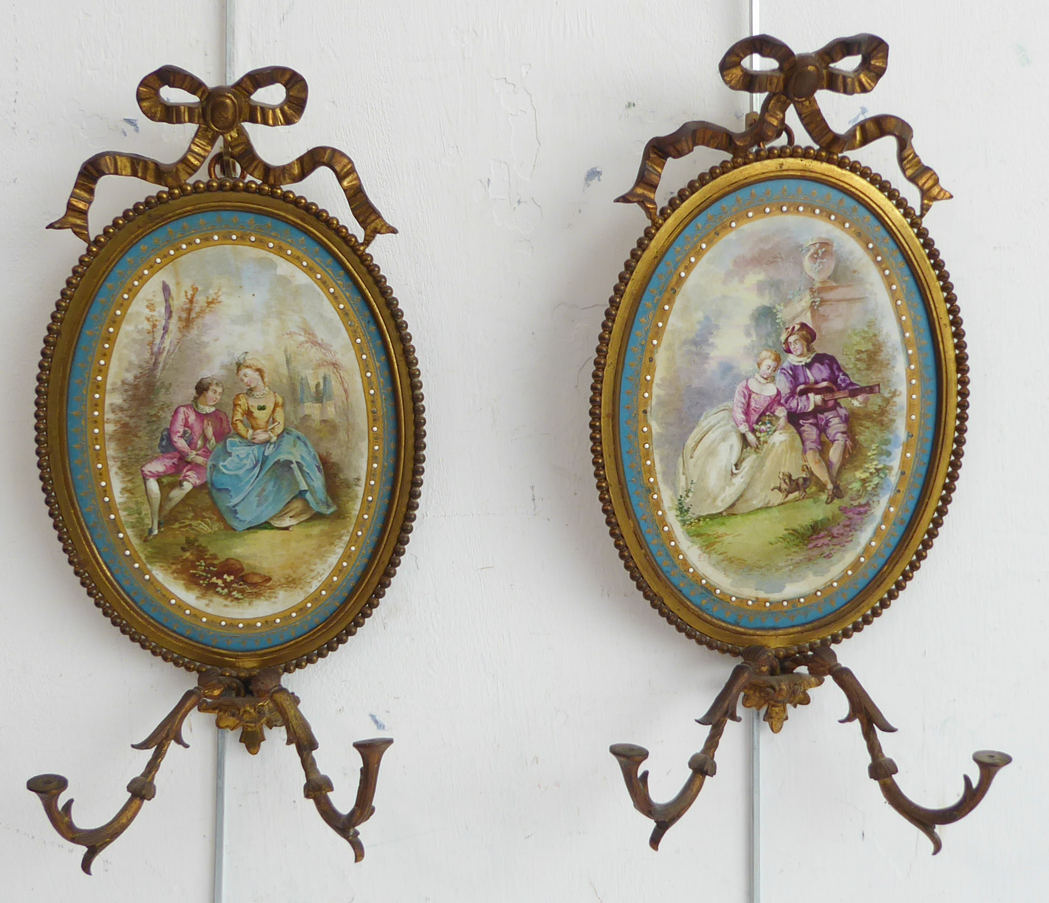 A pair of 19th century French gilt-metal and oval porcelain girandoles (minus candleholders / drip