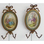 A pair of 19th century French gilt-metal and oval porcelain girandoles (minus candleholders / drip