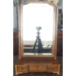 An 18th century walnut veneered and herringbone banded toilet mirror: the shaped plate flanked by