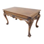 A good walnut coffee table in 18th century style: the quarter veneered crossbanded moulded top above