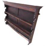 An 18th/19th century oak dresser rack (later backed); the shelves with unusual hooks as deer heads