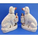 A large and rare pair of Staffordshire spaniels with male and female figure attached.