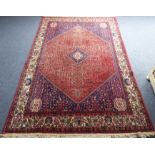 A large and modern Persian Shiraz carpet; large central rose-ground lozenge with cobalt-blue smaller