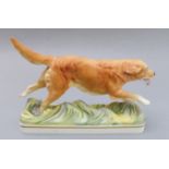 A hand-decorated Royal Worcester fine bone china model of a golden retriever. The underside