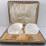 A highly unusual dessert set comprising five mother of pearl handled silver-bladed dessert knives